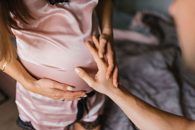 Attentive caucasian man caresses his pregnant woman's tummy person