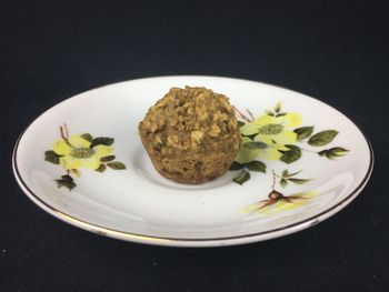 Close-up of food in plate against black background