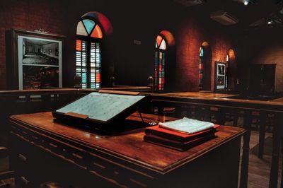 Empty chairs and table in illuminated room