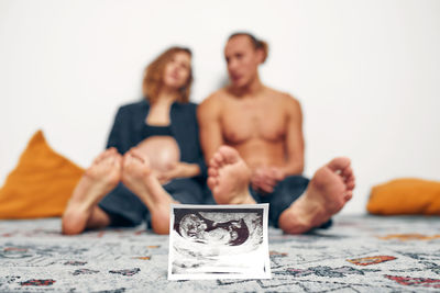 Portrait of smiling family sitting on table