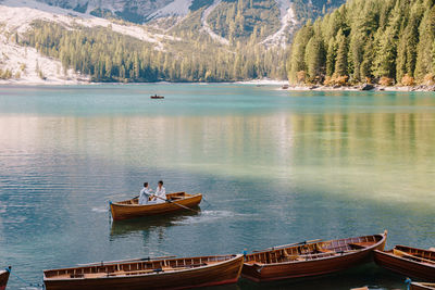 High angle view of people on lake by trees