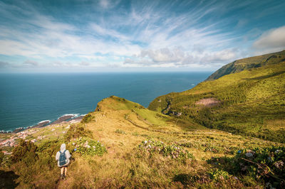 Azores islands, landscape with hiker in green vegetation, flores, travel destination for hiking.