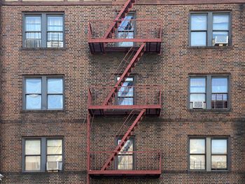 Low angle view of building red fire escape red bricks in mount vernon new york summer 2020