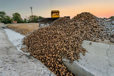 Earth mover at construction site against sky