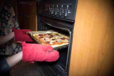 Midsection of woman having food at home