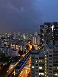 High angle view of illuminated buildings against sky at night