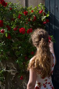 Woman standing against blooming flowers