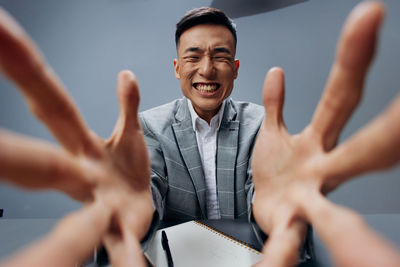 Angry businessman gesturing in office