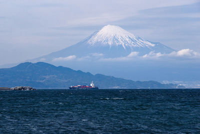 Scenic view of sea against sky with mt. fuji in background.