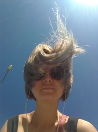 Close-up portrait of woman against sky