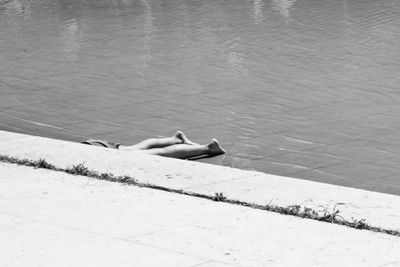 High angle view of shirtless man lying on swimming pool