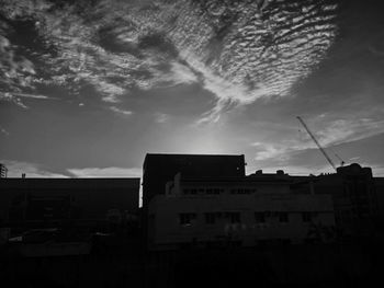Low angle view of buildings against sky at sunset