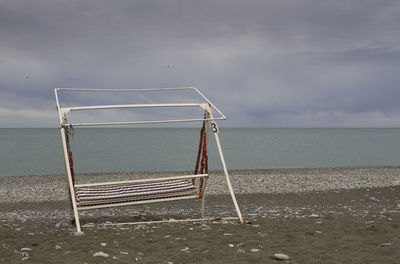 Lifeguard hut on beach against sky