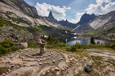 Scenic view of lake by mountains against sky