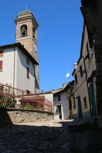 Low angle view of old building against clear blue sky