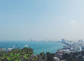 High angle view of buildings by sea against sky