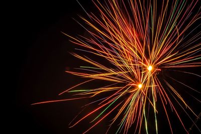 Low angle view of firework display at night