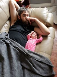 Portrait of baby sleeping on sofa at home