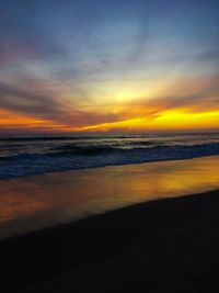 Scenic view of beach against sky during sunset