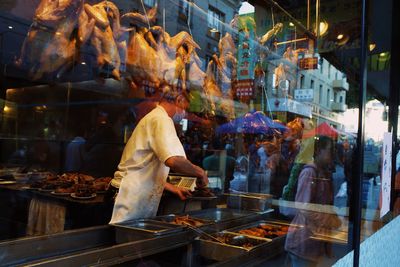 Rear view of man preparing food
