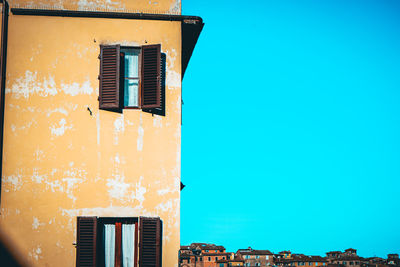 Low angle view of residential building against clear blue sky