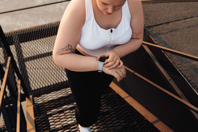 High angle view of woman standing on railing