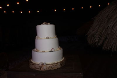High angle view of illuminated cake on table
