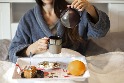 Hot tea cup and breakfast in bed,morning routine concept