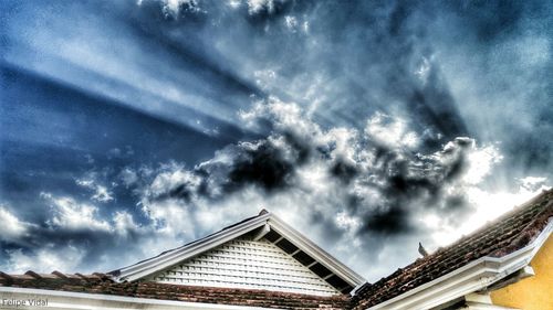 Low angle view of storm clouds over roof