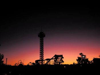 Low angle view of silhouette building against sky during sunset, outlying elitch gardens, denver, co