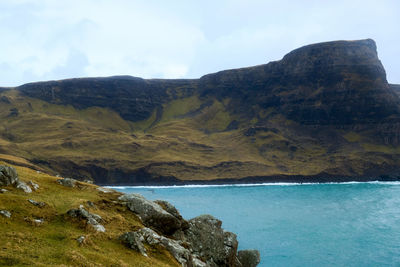 Scenic view of sea and mountains against sky