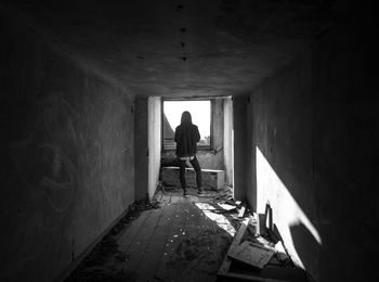 Rear view of man standing in tunnel