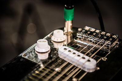 Close-up of guitar by knobs