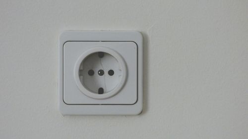 Close-up of electric lamp on wall