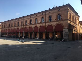 People on street against building in city