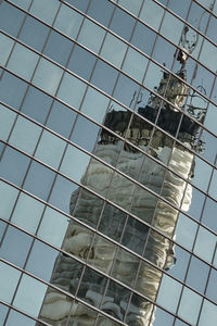 Low angle view of modern building against blue sky