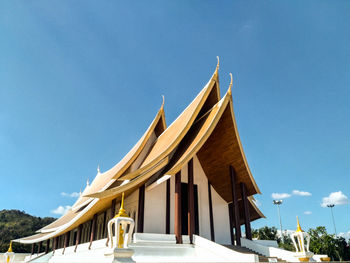 Low angle view of religious building against blue sky