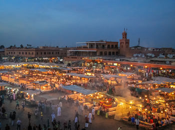 High angle view of illuminated buildings in city against sky at night