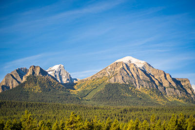 Scenic view of mountains against blue sky