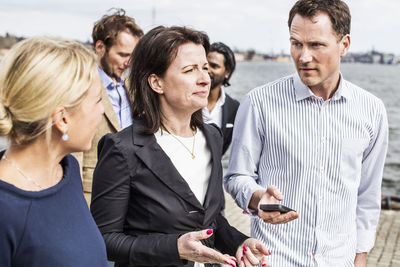 Business people discussing while standing outdoors