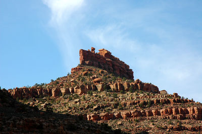 Low angle view of castle on mountain against sky