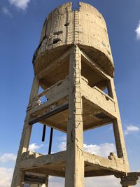 Low angle view of old water tower against sky