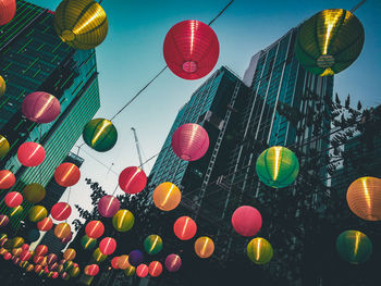 Low angle view of colorful lanterns hanging outside buildings