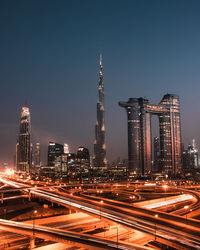 Illuminated modern buildings in city at night