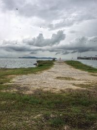 Scenic view of sea against cloudy sky