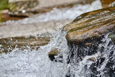 Close-up of water splashing on rock