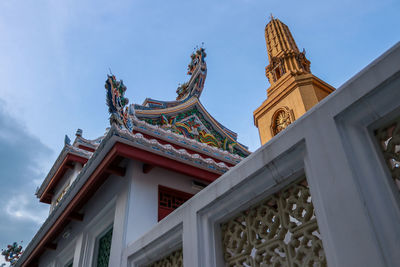 Low angle view of temple and building against sky