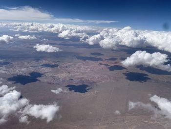 Aerial view of snowcapped landscape against sky