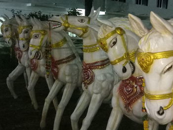 Close-up of sculptures hanging at market stall