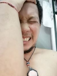 Close-up portrait of young man with eyes closed